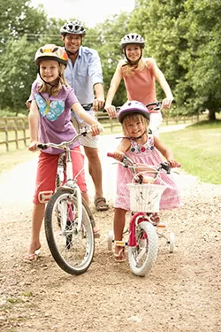 Family riding bikes in the park