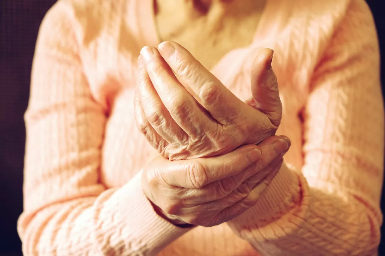 Close up of mature womans hands. Health care giving, nursing home. Parental love of grandmother. Old age related diseases.